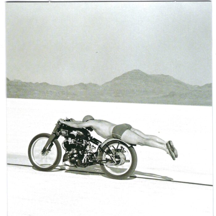 Rollie Free prone on a motorcycle in a bathing suit