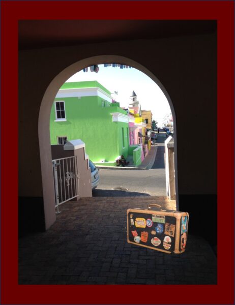 Archway in Capetown South Africa, with a suitcase covered with travel destination stickers