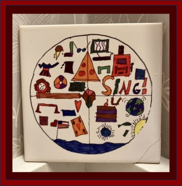 A child-painted tile with a repaired corner